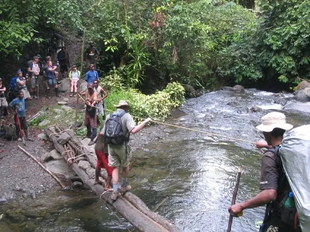 Crossing a creek on a log bridge