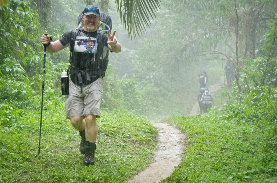 A trekker walking in rain on the Kokoda Track